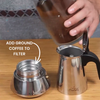 Silver metal Any Morning moka pot disassembled on a wood surface with text reading add ground coffee to filter.