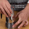 Two hands assembling a silver metal Moka Pot on a wood surface with text: screw the top to the bottom.